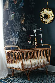 a baby crib sitting in front of a window