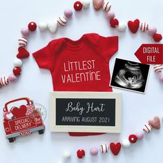 a baby's bodysuit and other items laid out on a table