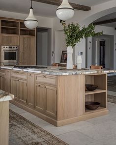 a large kitchen with an island in the middle and lots of counter space on each side