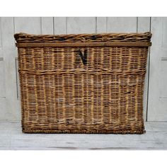 a large wicker basket with the letter v on it's front and bottom