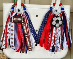 two bags with ribbons attached to them are decorated like american footballs and soccer balls