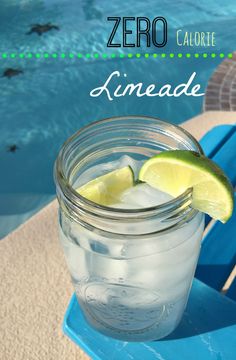 a mason jar filled with ice and lime next to a swimming pool that reads zero calorie