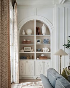 a living room filled with furniture next to a window