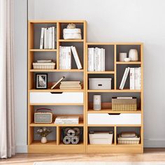 a bookshelf filled with lots of books next to a window