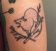 a tattoo on the arm of a person with a bear and arrow in it's head