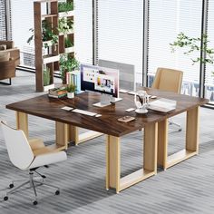 a wooden table sitting in an office next to two chairs and a desk with a computer on it