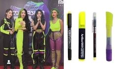 the girls are wearing neon colored clothes and holding microphones in their hands while standing next to each other