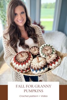 a woman holding a plate full of crochet pumpkins with the words fall for granny written on it