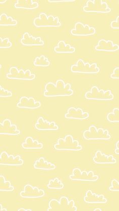 a yellow background with white clouds on it