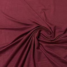 an image of a plain maroon colored material that looks like it has been folded up