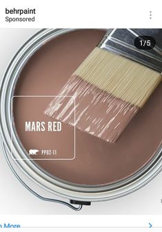 a paint can with a brush in it and the words mars red painted on it