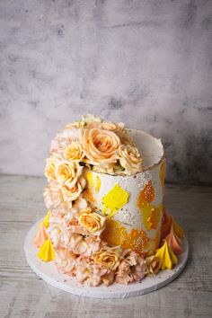 a white and yellow cake with flowers on it