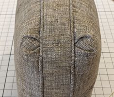 the back end of a gray and white ottoman with buttons on it's sides