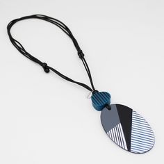 Elevate your style with our Contemporary Black White and Teal Solene Pendant. The oval pendant boasts an angled design, adding a modern touch to any outfit. With an adjustable length, this sophisticated piece is perfect for any occasion. Make a statement with our luxurious pendant. Adjustable length: 16" to 32"  Bead Dimensions:  2" W x 3 1/2" L Care Instructions: Remove jewelry when applying perfumes, creams, washing hands, etc. Do not store in direct sunlight. To restore color and shine, apply Modern Black Oval Pendant Necklace, Washing Hands, Statement Pendant, Oval Pendant, Modern Pendant, Beaded Necklace, Jewelry Necklaces, Accessory Gift, Black White