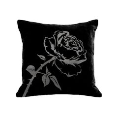 a black and white pillow with a rose on it