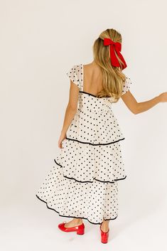 the retro-inspired dress of our dreams. it features sheer short sleeves, a ribbon tie bodice, + dainty ruffle details. both sweet + sophisticated, this off-white + black polka dot midi dress is perfect for fancy dinner dates, holiday parties, + anytime you’re feelin’ frilly. off white + black polka dots // midi length, sweetheart neckline, sheer polka dot sleeves, back zipper closure, tiered skirt, lined model is 5'8" + wearing a small measurements are approximate + taken while laying flat xsmal Retro Inspired Dress, Polka Dot Midi Dress, Dinner Dates, Sheer Shorts, Fancy Dinner, Date Dinner, Tier Skirt, Ribbon Tie, Inspired Dress