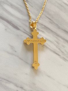 "The fleur-de-lis is a popular symbol of a stylized lily flower that is adorned across Christian architecture and artifacts. It is a symbol of purity and strength. Premium Sterling Silver Chain Included: Includes our signature sterling silver 925 chain that is offered in 16\", 18\", 20\", or 24\". Pendant Length: 30 mm Pendant Width: 18 mm Materials & Crafting: 18K Gold Vermeil: Solid sterling silver (highest quality and purity of silver used for fine jewelry) coated with a thick layer of 18 Elegant Cross Necklace For Memorial, Elegant Memorial Cross Pendant Necklace, Elegant Cross Pendant Jewelry For Memorial, Gold Crucifix Jewelry For Commemoration, Elegant Cross Jewelry For Memorial, Elegant Memorial Cross Jewelry, Gold Cross Pendant Necklace For Memorial, Gold Cross Pendant Necklace For Memorials, Lily Flower