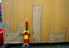 a child's drawing of a castle on the wall next to a toy fire hydrant