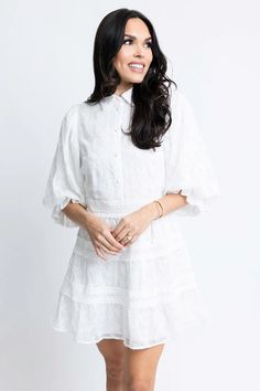 This eyelet lace dress exudes sophistication with its unique lace design and elegant button-up detail. Its classy look is further enhanced by its lining, making it a stylish choice for any occasion. But especially for Graduations! True to size Model is wearing small Color: white Button front detail Bubble Sleeves Back Zip Closure Lined Fabric has no stretch Polyester Daywear Mini Dress With Scalloped Lace, Elegant Mini Dress With Lace Collar For Spring, Elegant Short Sleeve Eyelet Dresses, Elegant Fitted Lace Dress With Broderie Anglaise, Chic Lace Dresses With Buttons, Summer Wedding Dress With Eyelet Details, Spring Lace Mini Dress With Eyelet Details, Spring Lace Mini Dress With Eyelet, Spring Eyelet Lace Mini Dress