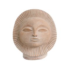 a white statue with a sun face on it's head, against a white background