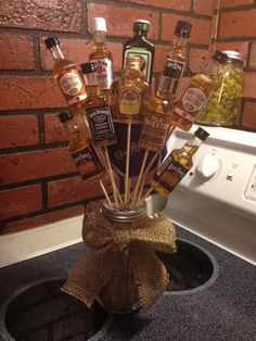 a glass jar filled with liquor bottles on top of a stove