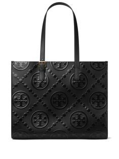 black nappa leather embossed monogram pattern two adjustable top handles main compartment microfibre lining internal zip-fastening pocket internal slip pocket This piece comes complete with a protective dust bag. Tory Burch Tote Bag, T Monogram, Tory Burch Tote, Tory Burch Bag Totes, Side Snap, Monogram Handbag, Black Leather Tote Bag, Monogram Pattern, Denim Tote