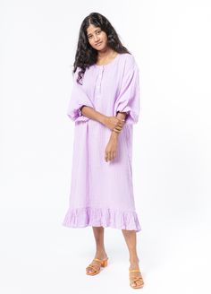 The Bathtan is our take on the classic caftan, a house dress made for wearing after the bath and beyond. The pillowy soft 100% cotton gauze feels like stepping into a delicate purple cloud, while the elasticized sleeves, bottom ruffle and functional collar buttons add the perfect touch of tailoring. Product Details: 100% cotton S/M fits up to US dress size 10. Measurements are 47" length, 23" shoulder (across back), 23" waist (across back), 19" sleeve Sizing transparency: As this is a new produc Relaxing Cotton Dresses, Cotton Dresses For Relaxation, Spring Daywear Cotton Gauze Maxi Dress, Spring Cotton Gauze Dresses For Loungewear, Spring Cotton Gauze Loungewear Dresses, Spring Cotton Gauze Maxi Dress For Daywear, Cotton Beach Nightgown With Ruffles, Beach Nightgown With Ruffles In Cotton, Bohemian Cotton Sleep Dresses