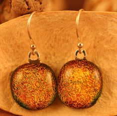 I designed these stunning earrings using a dichroic glass in a warm orange-yellow hue.   Perfect for summer or that rainy day.   They measure approximately 12mm in diameter.  Mounted on sterling silver fishhook style earrings.   Everything in my shop is handmade by me in my home studio. Thanks for buying handmade... Paula Orange Starburst, Witch Pendant, Dichroic Glass Earrings, Fused Glass Earrings, Quirky Earrings, Fused Glass Jewelry, Tampa Fl, Dangly Earrings, Stunning Earrings