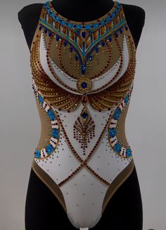 a woman's bodysuit with gold, blue and white designs on it is shown