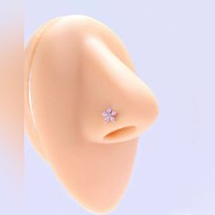 a close up of a fake nose with a ring on it's end and a flower in the middle