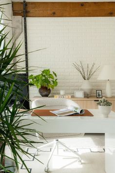 a white desk with some plants on it