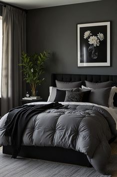 a bedroom with grey walls and black bedding