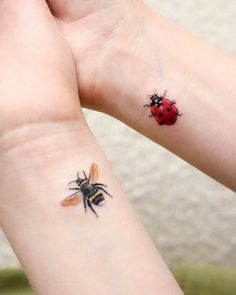 two ladybug tattoos on both wrist and arm, one with a red bug