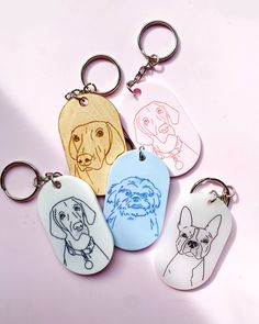 four dog tags with different dogs on them sitting next to each other in front of a pink background