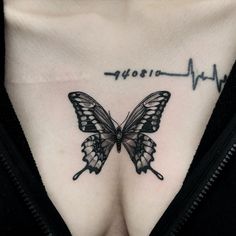 a woman's chest with a butterfly tattoo on it