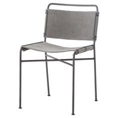 a gray chair sitting on top of a white floor next to a black metal frame