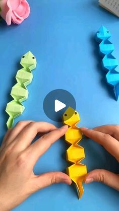 someone is making origami fish out of paper