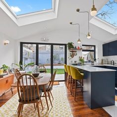 an open kitchen and dining room with skylights