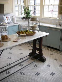 a kitchen filled with lots of counter top space and food on the table in front of it