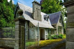 an old house with a gate in front of it