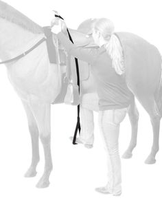 a black and white photo of a woman standing next to a horse