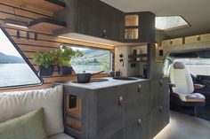 the interior of a camper with a kitchen and living area