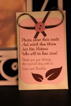 a pink card with a brown ribbon and some words on the back that say please plant these seeds and watch them bloom