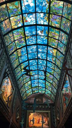 the inside of a building with stained glass ceiling