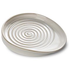 a white plate with spiral design on the rim and bottom, sitting in front of a white background