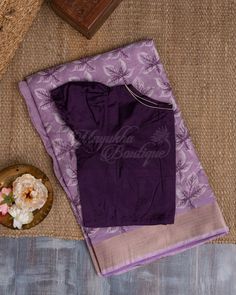 A Saree That Is Gorgeous In Lavender And Features Chanderi Block Printing Would Be A Classy And Striking Alternative. The Soft Glossy Tone With Floral Prints, When Combined With A Kaddi Border And A Pallu Embellished With Flower Patterns, Would Give The Saree A Delicate And Elegant Look. A Stylish Purple Contrast Blouse Is Worn With It. Lavender And Purple Outfit, Lavender Colour Saree Contrast Blouse, Purple Colour Combinations Saree, Lavendar Saree Contrast Blouse Ideas, Purple Colour Saree Contrast Blouse, Purple Unstitched Blouse In Cotton Silk Traditional Wear, Festive Unstitched Lavender Blouse Piece, Traditional Lavender Unstitched Blouse Piece, Festive Lavender Unstitched Blouse Piece