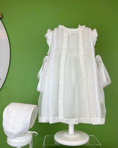 A delicate dress and bonnet made in white organza with pleats and laces. The dress has two ribbon bows on the sides, and buttons on the back for closure. Made in Spain Dry clean Final sale, no exchanges nor returns are available White Baptism Dress, Baptism Dresses, Delicate Dress, Christening Dresses, Dress For Baby Girl, Dress For Baby, Spanish Fashion, Baptism Dress, Christening Dress