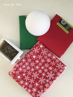 the snowflake is on top of the red and green folders, which are next to each other