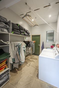 the laundry room is clean and ready to be used as a storage space for clothes