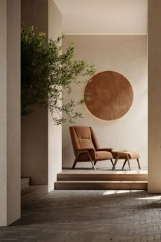 an empty room with two chairs and a potted plant on the floor next to it